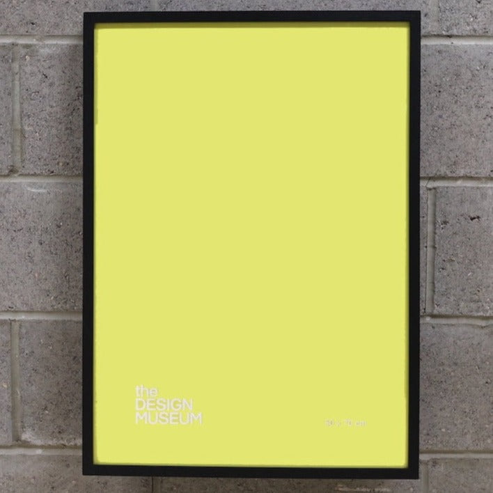 Yellow picture frame on a birck wall
