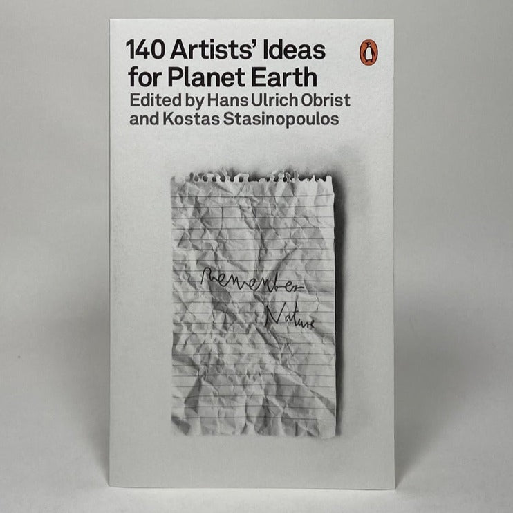 The cover of a book titled "140 Artists' Ideas for Planet Earth," with a minimalist design, featuring a monochrome photograph of a crumpled piece of paper with handwritten notes.