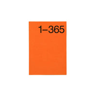 An orange rectangular planner with the black printed text '1-365' at the top, centered on a light gray background.
