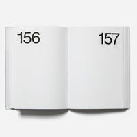 Open planner showing pages numbered 156 and 157 on a white background