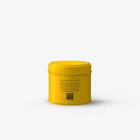 Yellow candle tin on a grey background
