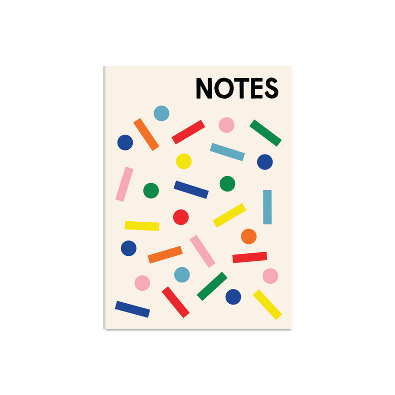A cream-colored notebook or notepad with the word 'NOTES' printed in bold black at the top, decorated with scattered colorful geometric shapes including circles, rectangles, and lines in blue, red, green, yellow, pink, and orange.
