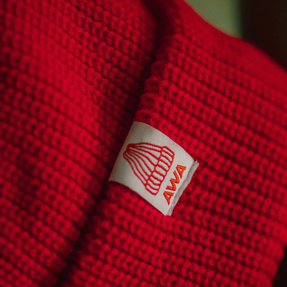 Red fabric with a brand logo on a blurred background