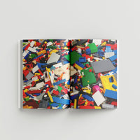 Inside page of Ai Weiwei catalogue with a photograph of colourful lego pieces.