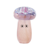 A colorful glass art piece resembling a blob with a face, crafted from melted shards of glass, with a primarily pink and purple color palette.