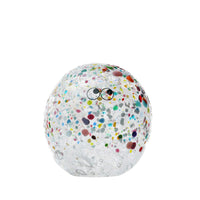 Transparent Arhoj crystal blob with colouful speckles and eyes on a white background.