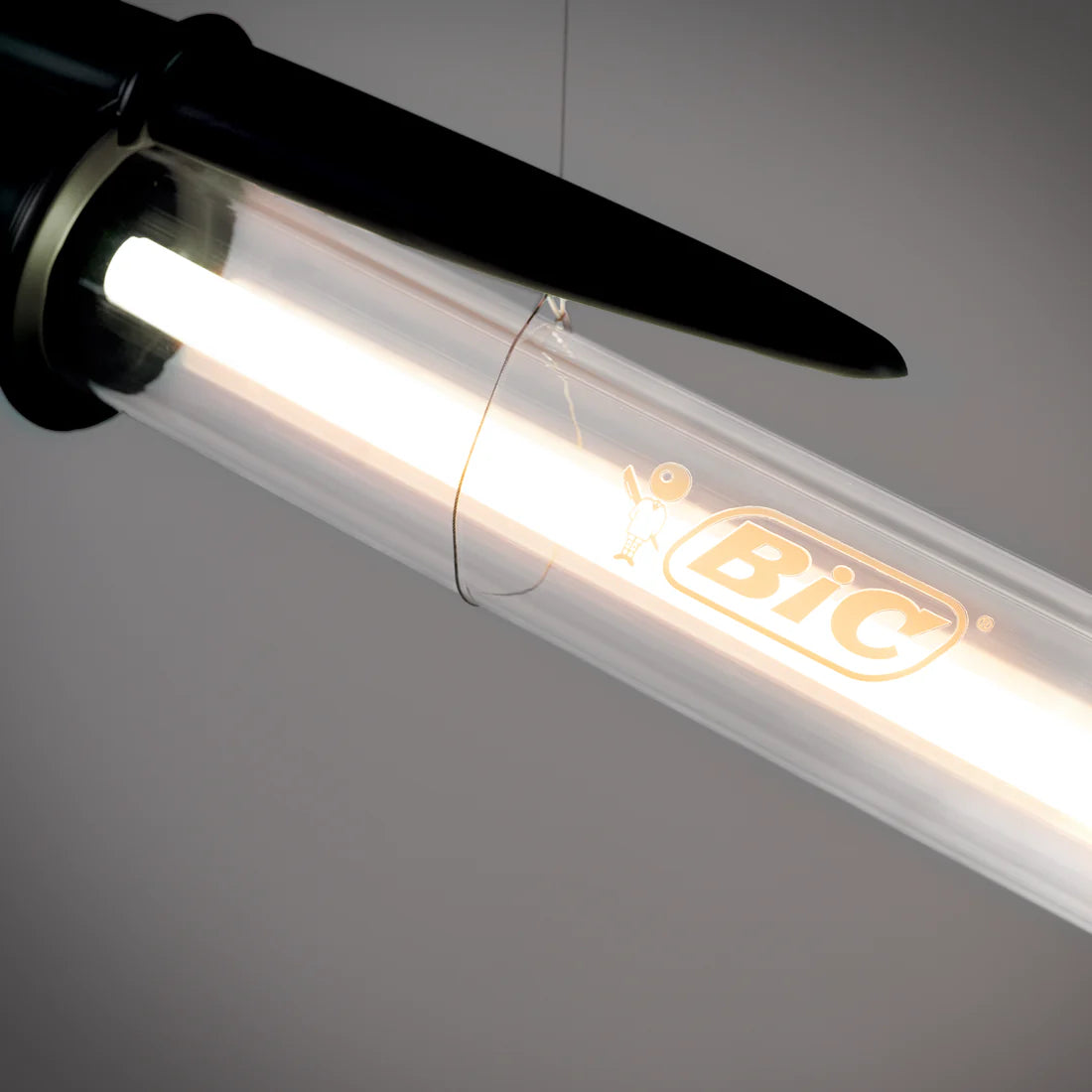 Black BIC pen lamp on a gray background