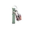 Green key holder on a white card with branding