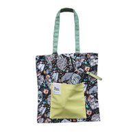 Tote bag with an abstract marbled pattern, with a yellow pouch and green handle on a white background