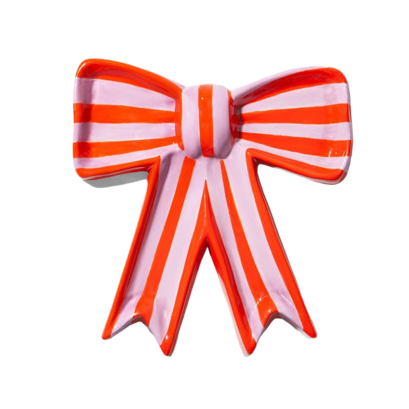 A ceramic trinket tray in a bow shape with red and pink stripes.