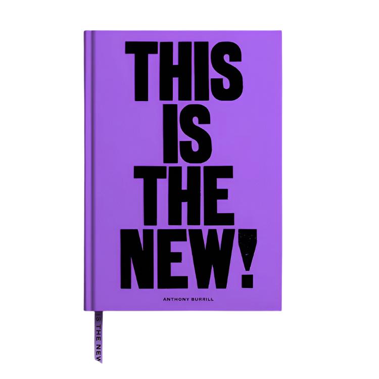 A purple A5 lined notebook with a black text 'This is THE NEW!' on the cover, designed by Anthony Burrill.