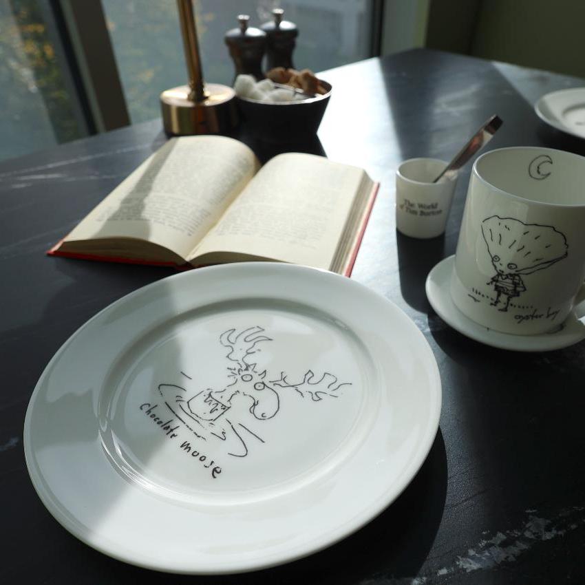 Tim Burton illustrated plate on a table in a kitchen