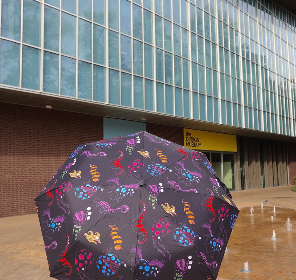 Tim burton patterned umbrella in front of the museum