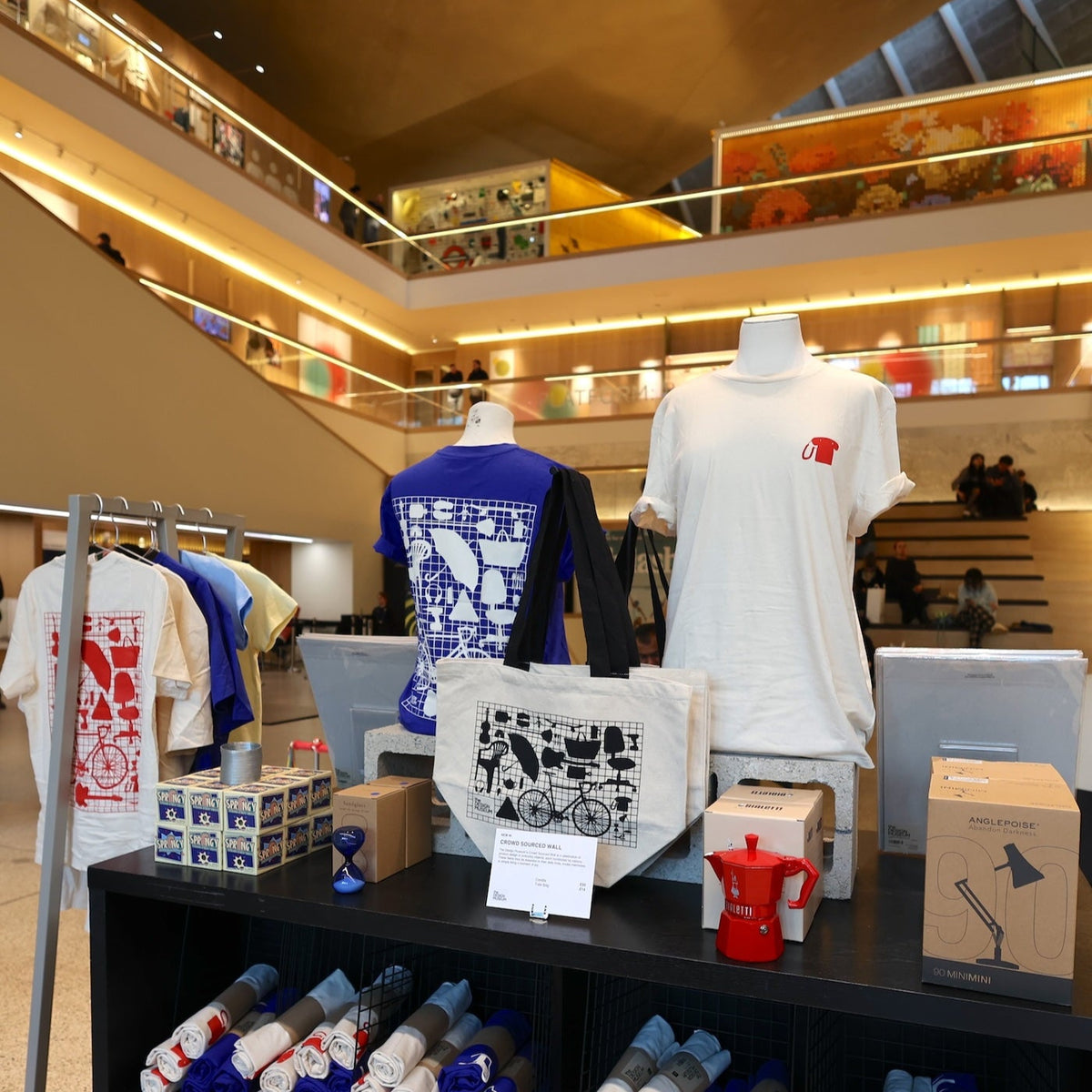 Picture of the Design Museum's Atrium shop display featuring t-shirts on mannequins and other items. 