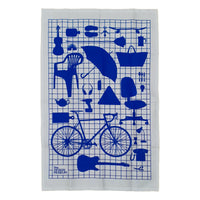 A white Tea towel with blue graphic design of everyday objects on a blue grid.