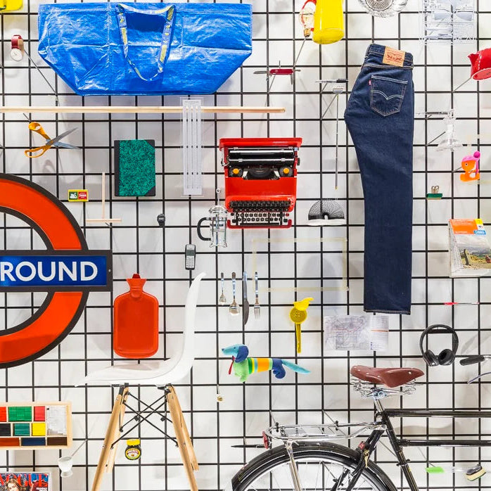 Collection of various items including jeans, a typewriter, and a bicycle on a grid background.