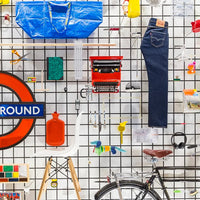 Collection of various items including jeans, a typewriter, and a bicycle on a grid background.