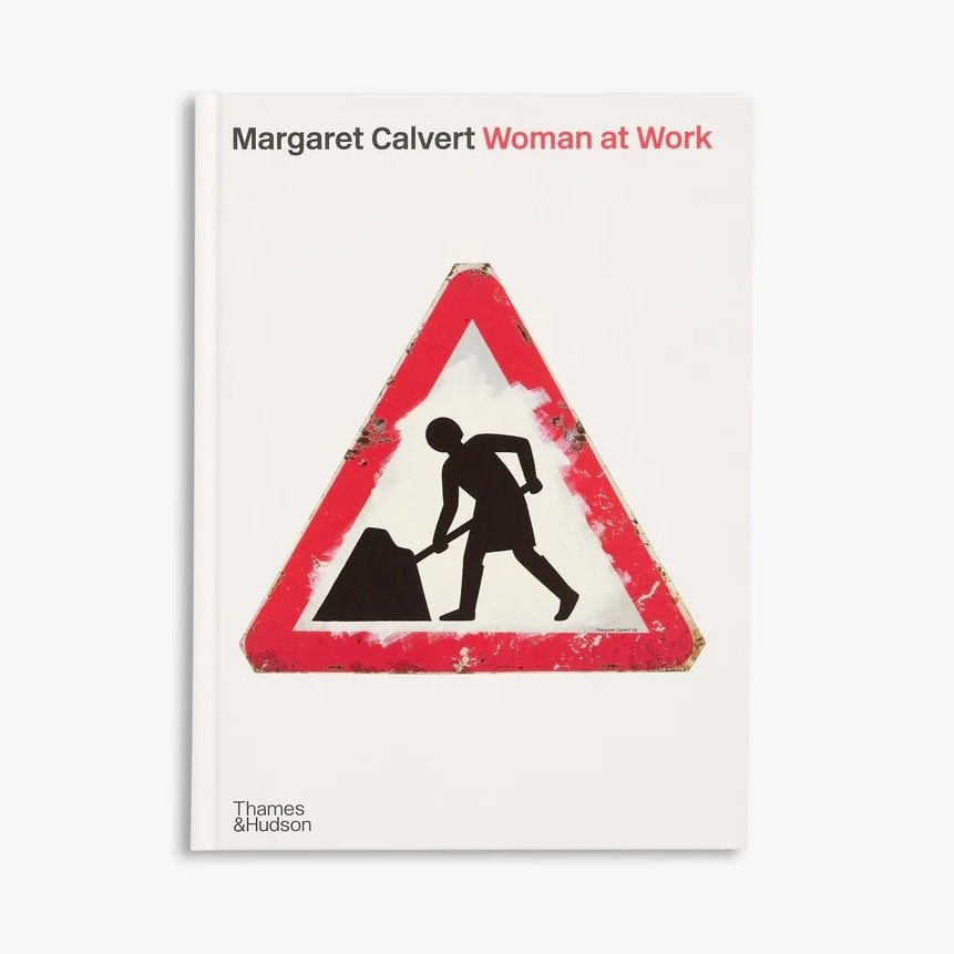 Book cover of 'Woman at Work' by Margaret Calvert with a warning sign design.