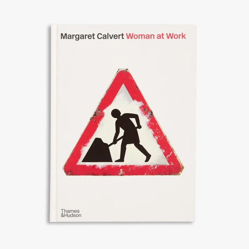 Book cover of 'Woman at Work' by Margaret Calvert with a warning sign design.
