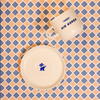 Ceramic items with 'Air Korda' branding on a patterned background