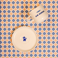 Ceramic items with 'Air Korda' branding on a patterned background