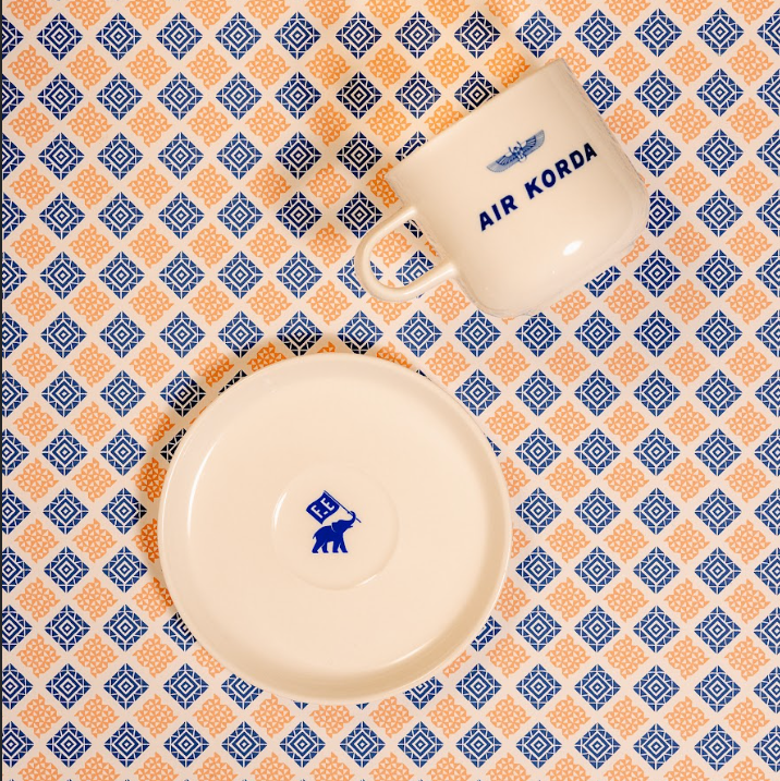 Ceramic items with 'Air Korda' branding on a patterned background