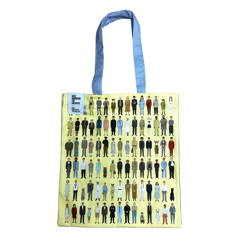 Tote bag with a pattern of small figures on a wooden surface