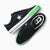 Green white and black trainers on a white background