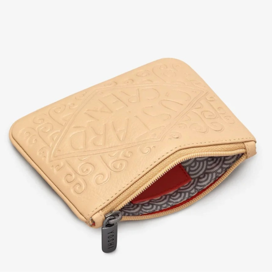 Open custard cream shaped leather purse on a white background