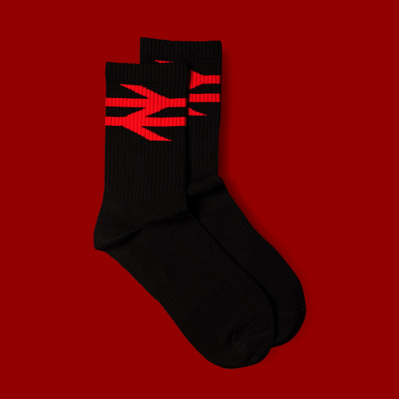 Black socks with red logo on a red background