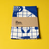 Folded fabric with blue and white pattern on a yellow background