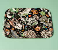 Decorative tray with mosaic design on a light green background