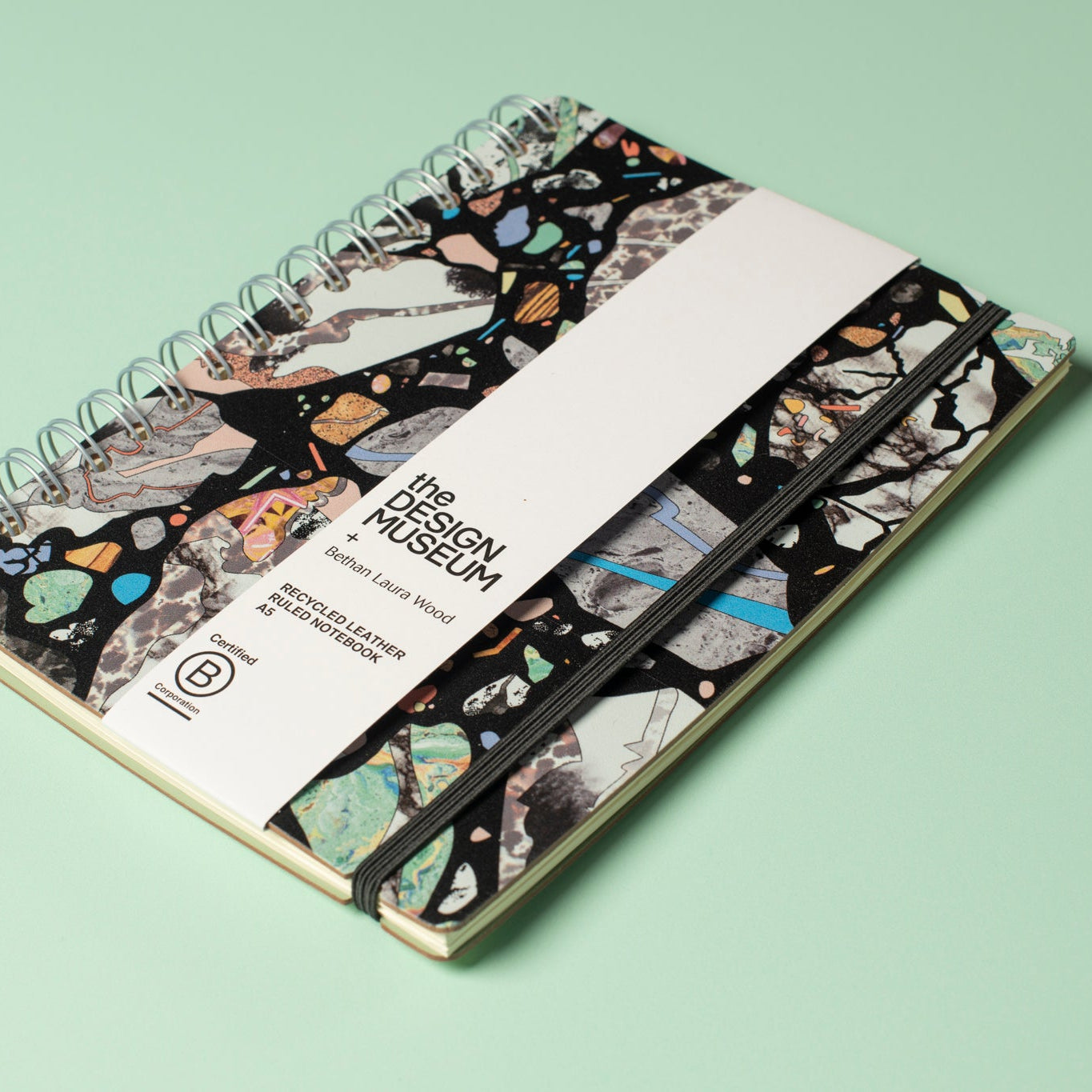 Notebook with a patterned cover on a light green background