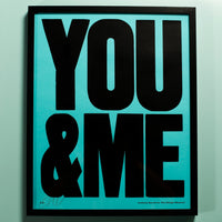 Framed artwork with 'YOU & ME' text on a light blue background