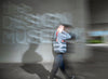 Person walking past the Design Museum with a bag, blurred motion effect