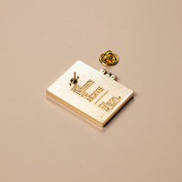 Gold badge with text on a beige background