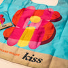 Colorful reusable bag with 'kiss' branding on a light surface