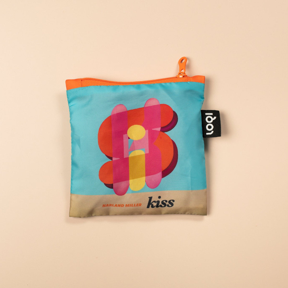 Small pouch with colorful design and 'kiss' branding on a beige background