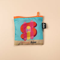 Small pouch with colorful design and 'kiss' branding on a beige background