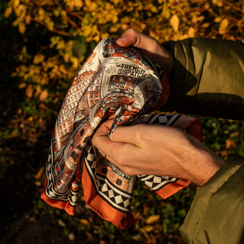 Wes Anderson scarf with leaves in the background
