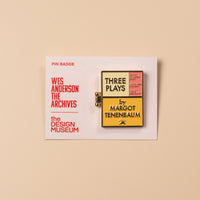 Pin badge with text on a beige background