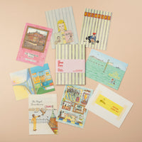 Collection of vintage-style greeting cards and stationery items on a beige background