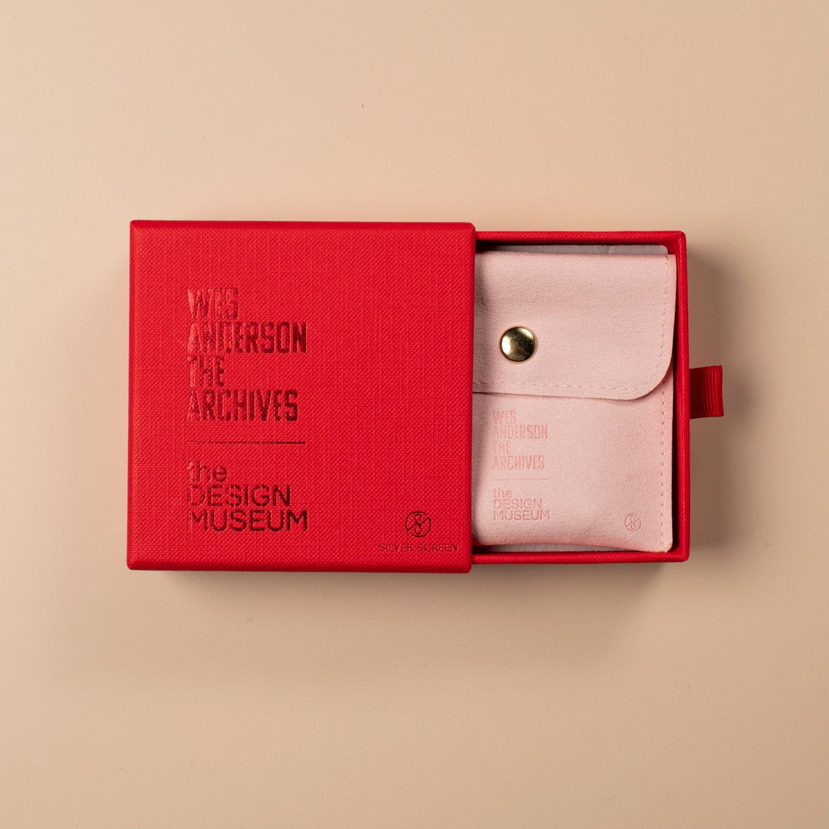 Red box with a white product inside on a beige background