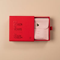 Red box with a white product inside on a beige background