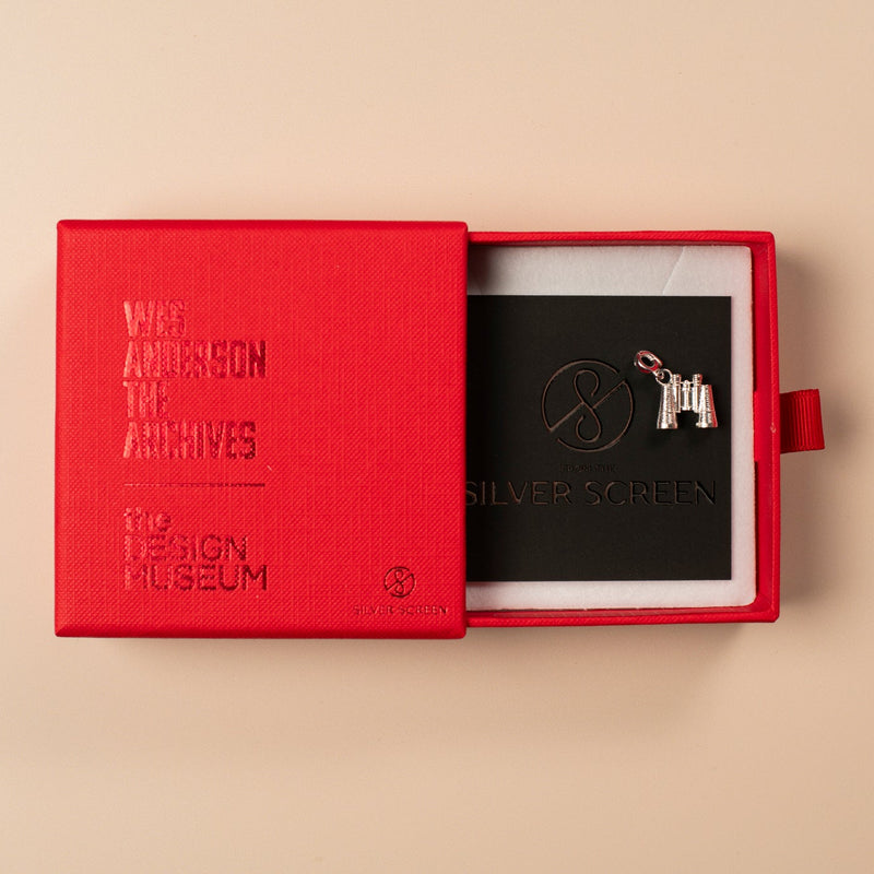 Red box with 'V&A Design Museum' branding, containing a silver object on a beige background