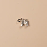 Silver binocular charm on a beige background