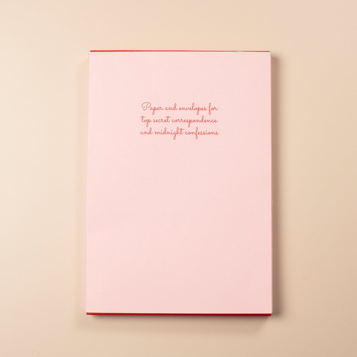 Pink card with red text on a beige background