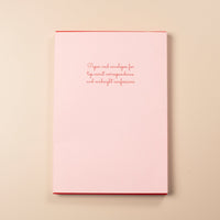 Pink card with red text on a beige background