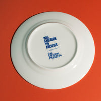 White plate with blue text on a red background