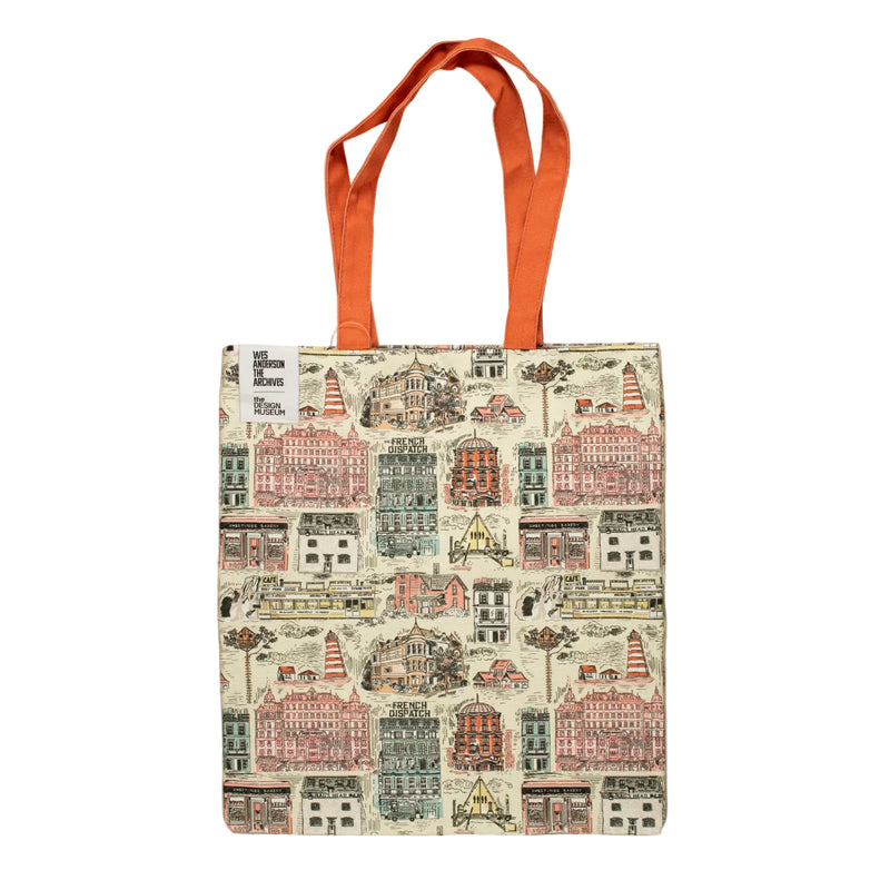 Tote bag with cityscape design and orange handle on beige background